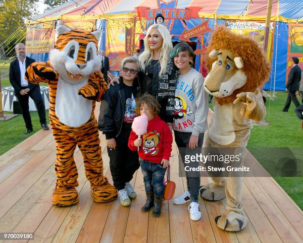 Zuma Rossdale, Apollo Bowie Rossdale, Gewn Stefani and Kingston Rossdale pose with costumed performers during the Moschino Spring/Summer 19 Menswear...