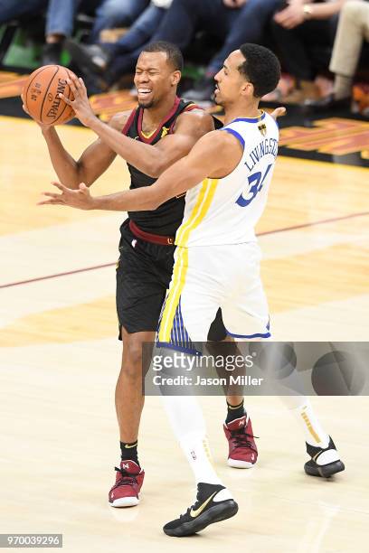 Rodney Hood of the Cleveland Cavaliers is defended by Shaun Livingston of the Golden State Warriors in the first half during Game Four of the 2018...