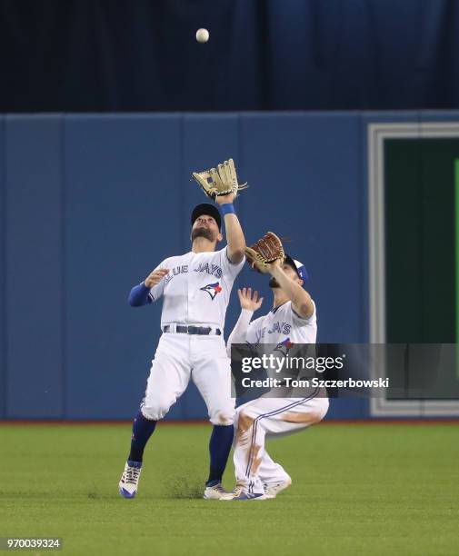 Kevin Pillar of the Toronto Blue Jays catches the final out of the game as Randal Grichuk gets out of his way in the ninth inning during MLB game...