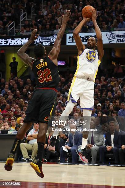 Kevin Durant of the Golden State Warriors attempts a jumper over Jeff Green of the Cleveland Cavaliers in the first half during Game Four of the 2018...