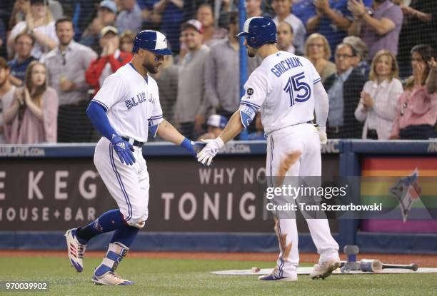 Kevin Pillar of the Toronto Blue Jays is congratulated by Randal Grichuk after hitting a solo home run in the eighth inning during MLB game action...