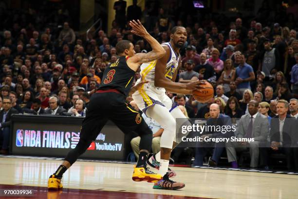 Kevin Durant of the Golden State Warriors defended by George Hill of the Cleveland Cavaliers in the first half during Game Four of the 2018 NBA...