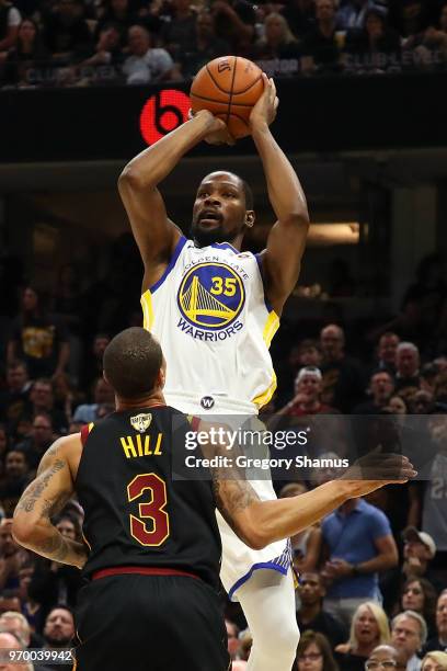 Kevin Durant of the Golden State Warriors shoots a jumper over George Hill of the Cleveland Cavaliers in the first half during Game Four of the 2018...