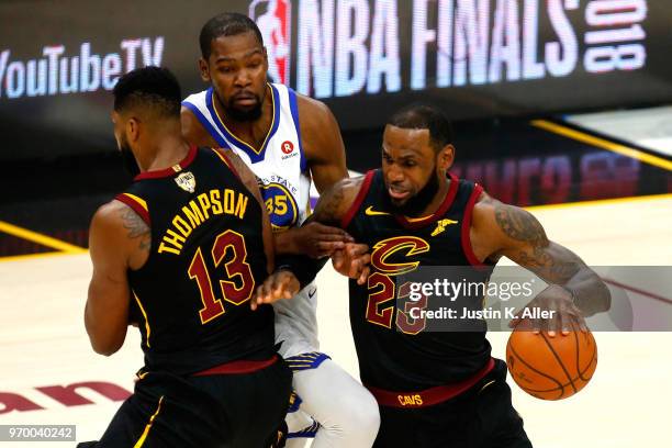 LeBron James of the Cleveland Cavaliers handles the ball against Kevin Durant of the Golden State Warriors in the first half during Game Four of the...