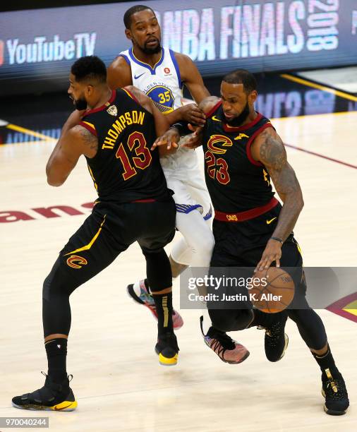 LeBron James of the Cleveland Cavaliers handles the ball against Kevin Durant of the Golden State Warriors in the first half during Game Four of the...