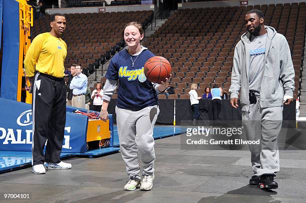 Assistant coach Adrian Dantley and Ty Lawson of the Denver Nuggets teach some basketball skills to an athlete from the Special Olympics of Colorado...