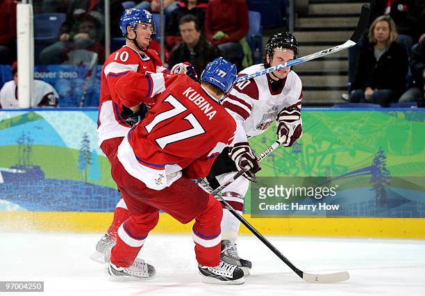 Lauris Darzins of Latvia is hit in the face by the stick belonging to Pavel Kubina of Czech Republic during the ice hockey Men's Play-off...