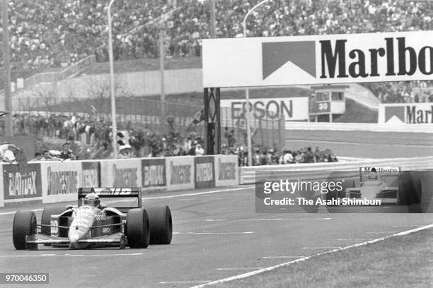 Alessandro Nannini of Italy and Benetton-Ford leads to Ayrton Senna of Brazil and McLaren-Honda during the race of the Formula One Japanese Grand...