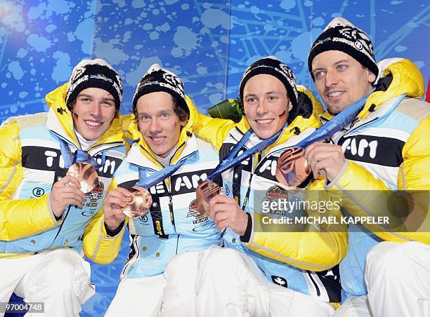 German bronze medallists Johannes Rydzek, Tino Edelmann, Eric Frenzel and Bjoern Kircheisen pose for photographers during the medal ceremony for the...