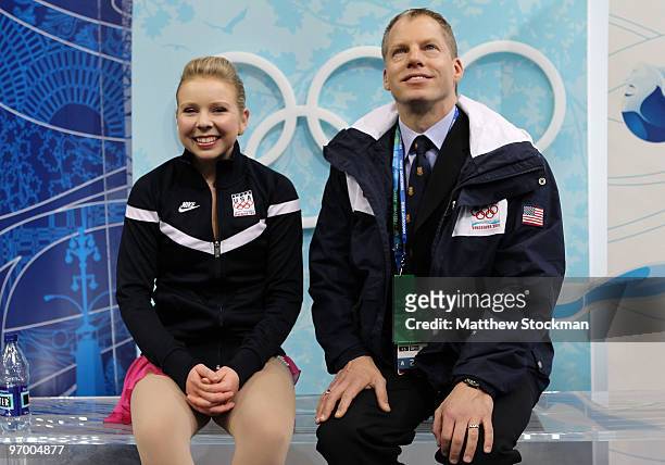 Rachael Flatt of the United States, accompanied by her coach Tom Zakrajsek, reacts after competing in the Ladies Short Program Figure Skating on day...
