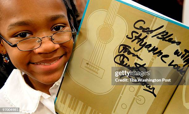 Martin Luther King Elementary school fifth grader Shyanne Carpenter showed off her copy of Leo Dillon's book "Jazz on a Saturday Night" that was...