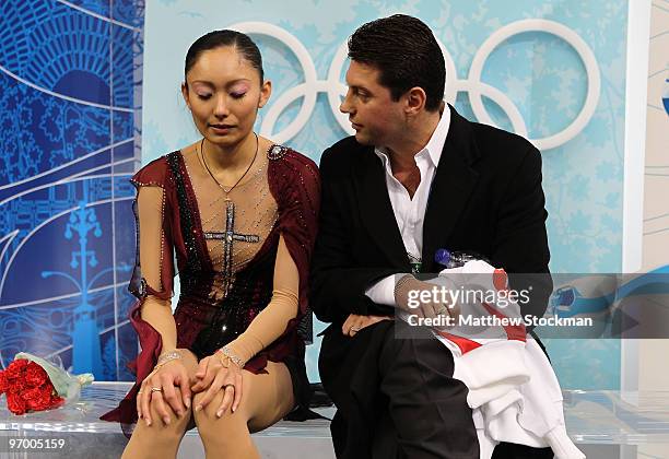 Miki Ando of Japan, accompanied by her coach Nikolai Morozov, reacts after competing in the Ladies Short Program Figure Skating on day 12 of the 2010...