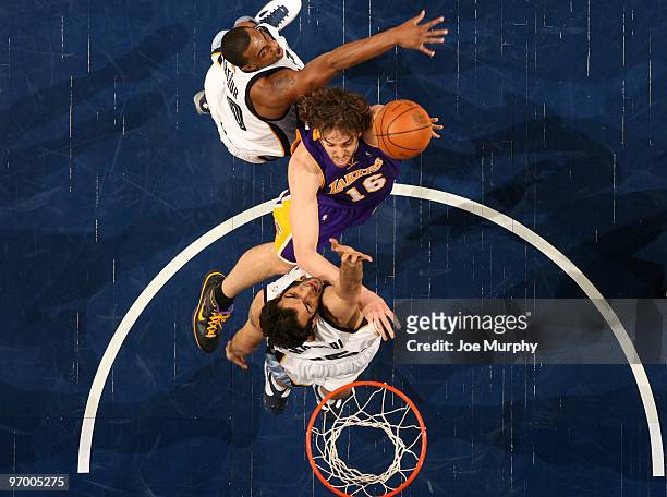 Pau Gasol of the Los Angeles Lakers shoots over Darrell Arthur and Hamed Haddadi of the Memphis Grizzlies on February 23, 2010 at FedExForum in...
