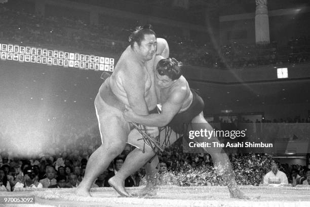 Yokozuna CHiyonofuji pushes yokozuna Onokuni out of the ring to win on day fourteen of the Grand Sumo Autumn Tournament at Ryogoku Kokugikan on...