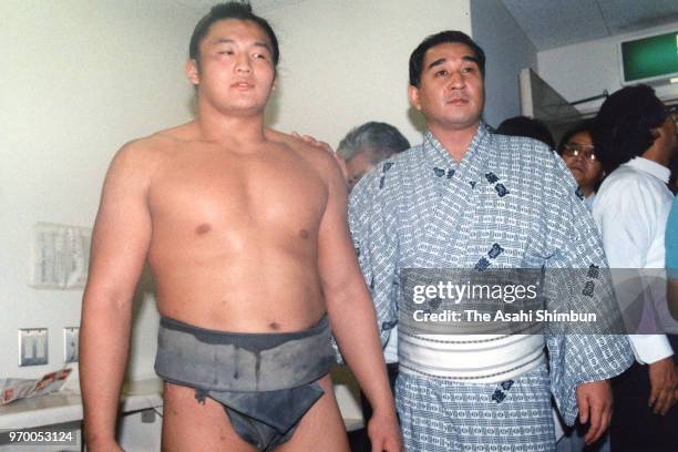Takahanada is congratulated by his father and stablemaster Fujishima after winning in the Makushita rank on day thirteen of the Grand Sumo Autumn...