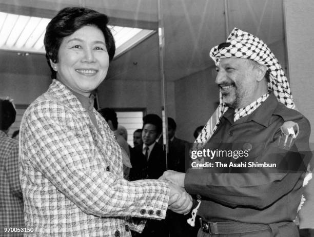 Palestine Liberation Organization Chairman Yasser Arafat shakes hands with Social Democratic Party leader Takako Doi during their meeting on October...