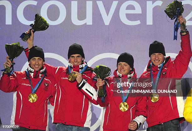 Austrian Gold medallists Bernhard Gruber, David Kreiner, Felix Gottwald and Mario Stecher stand on the podium during the medal ceremony for the...