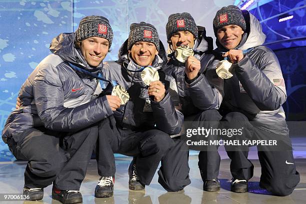 Silver medallists Brett Camerota, Todd Lodwick, Johnny Spillane and Bill Demong stand on the podium during the medal ceremony for the Nordic combined...