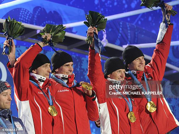 Austrian Gold medallists Bernhard Gruber, David Kreiner, Felix Gottwald and Mario Stecher pose for photographers during the medal ceremony for the...