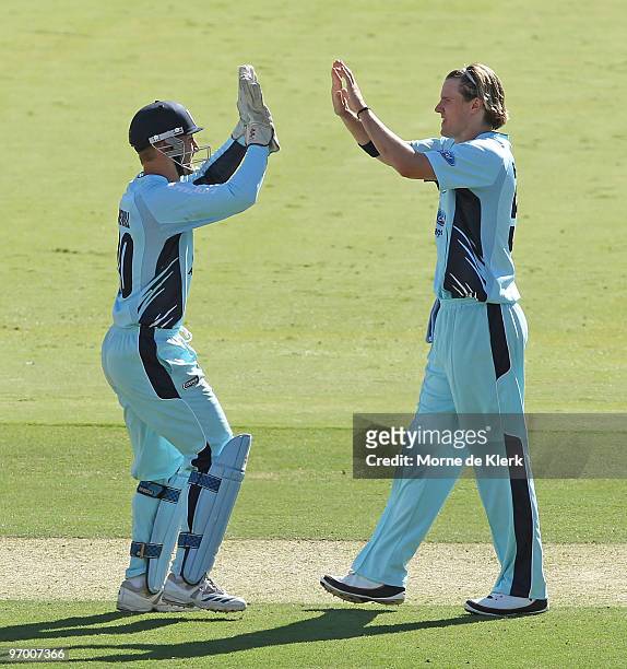 Players Peter Nevill and Nathan Bracken celebrate the wicket of Graham Manou during the Ford Ranger Cup match between the South Australian Redbacks...