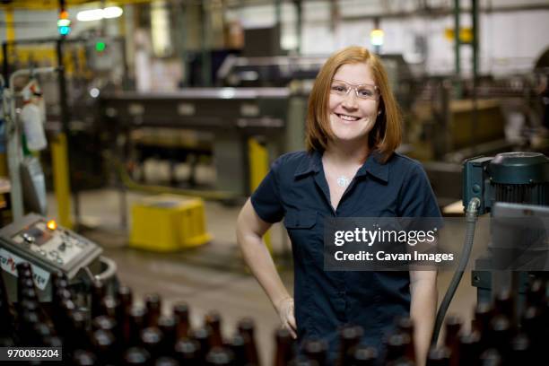portrait of smiling woman standing at distillery - bottling plant stock pictures, royalty-free photos & images