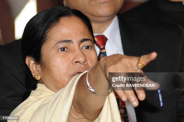 Indian Railway Minister Mamata Banerjee gestures as she arrives at Parliament House in New Delhi on February 24 to present the Railway Budget for...