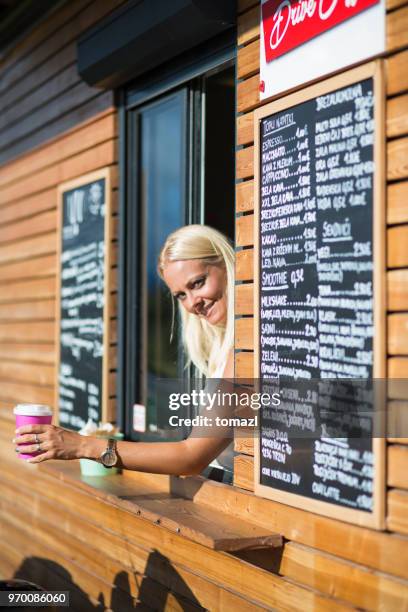 drive-in caffe clerk with smoothie - drive through stock pictures, royalty-free photos & images