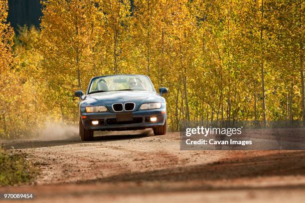 man driving car on dirt road - front view of car stock pictures, royalty-free photos & images