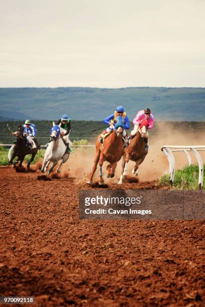 horse race on field against clear sky - jockey stock-fotos und bilder