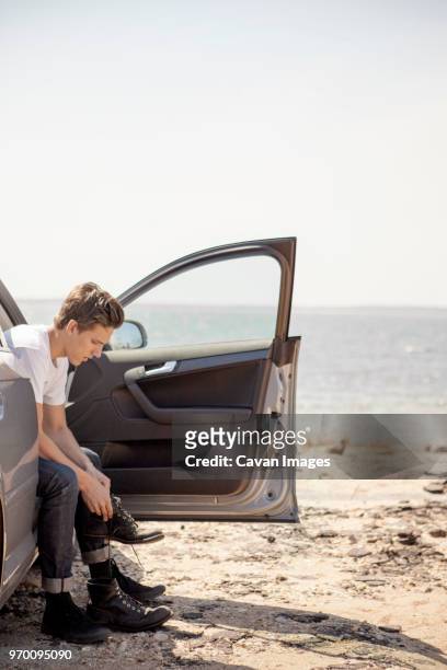 man wearing shoes while sitting in car - car isolated doors open stock pictures, royalty-free photos & images