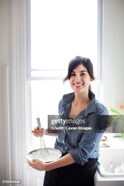 portrait of woman preparing whipped cream at home - whipping woman stock pictures, royalty-free photos & images