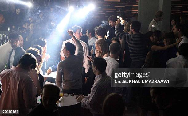 Young Jordanians and foreigners gather at a nightclub in Amman late on January 22, 2010. Discotheques, music bars and shisha lounges that have...