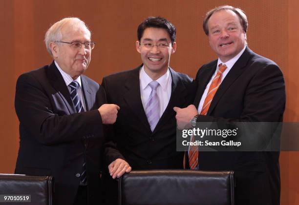 German Economy Minister Rainer Bruederle and Development Minister Dirk Niebel indicate to Health Minister Philipp Roesler at the weekly German...