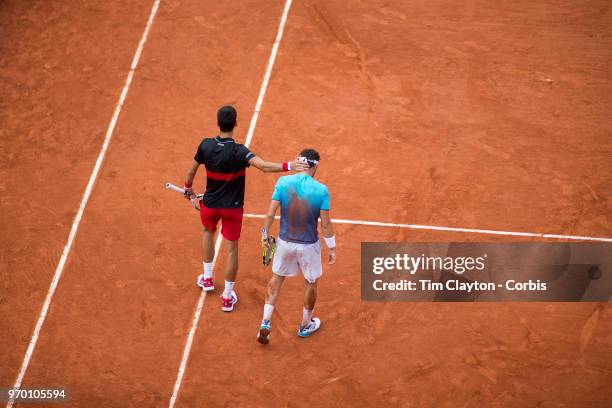 June 5. French Open Tennis Tournament - Day Ten. Marco Cecchinato of Italy is congratulated by Novak Djokovic of Serbia after his victory on Court...