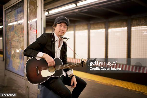 portrait of street musician in subway - harmonica stock-fotos und bilder
