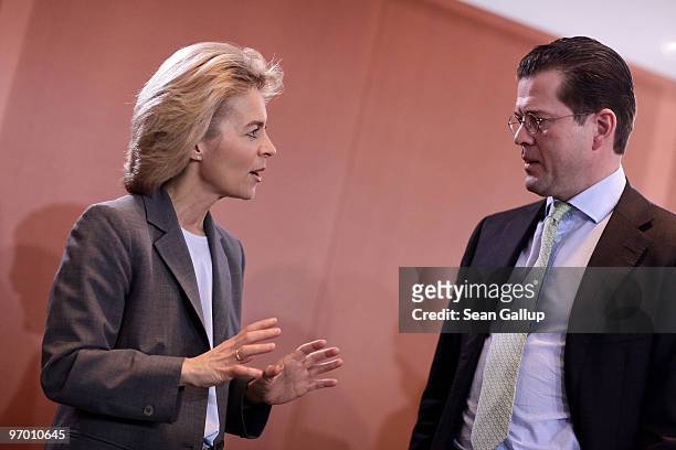 German Defense Minister Karl-Theodor zu Guttenberg chats with Minister of Work and Social Issues Ursula von der Leyen at the weekly German government...