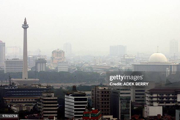 Jakarta landmarks, the Monas and the Istiqlal Grand Mosque are seen as the capital is blanketed by haze, 19 October 2006. Indonesia's government...