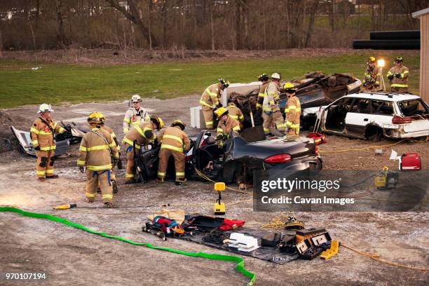 firefighters rescuing at practice drill - rescue worker stock pictures, royalty-free photos & images