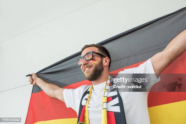 soccer fan cheering for national team at the game - supporter scarf stock pictures, royalty-free photos & images