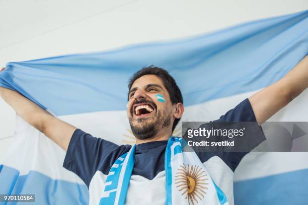 soccer fan cheering for national team at the game - argentina national soccer team stock pictures, royalty-free photos & images