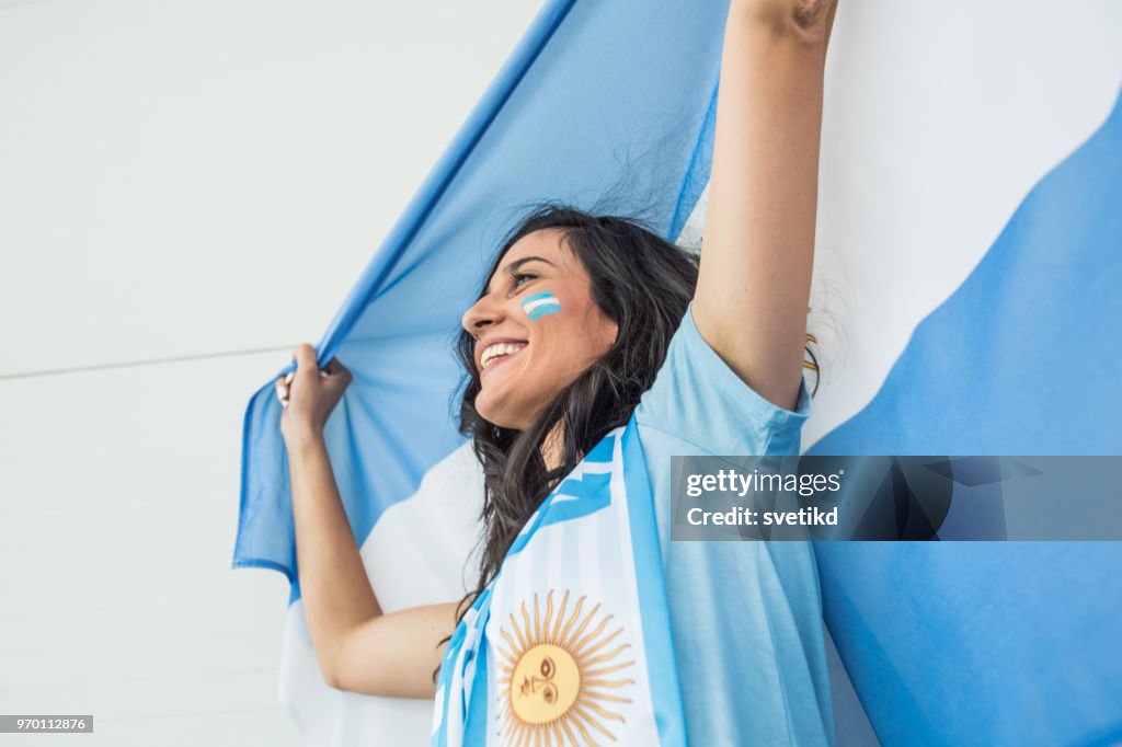 Soccer fan cheering for national team at the game