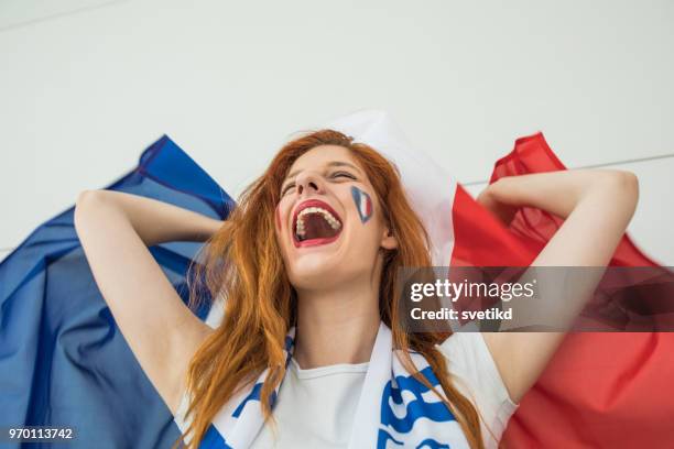 soccer fan cheering for national team at the game - france supporter stock pictures, royalty-free photos & images