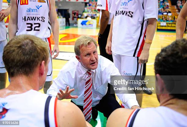 Coach Gordie McLeod of the Hawks talks to his players during a timeout during game two of the NBL semi final series between the Townsville Crocodiles...