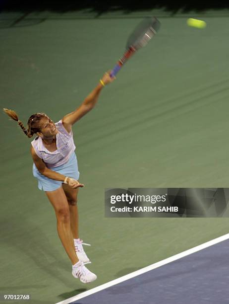 Melinda Czink of Hungary serves during her first round match against Flavia Pennetta of Italy on day two of the WTA Dubai Tennis Championships on...