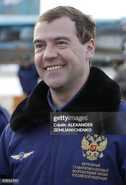 Russian President Dmitry Medvedev, wearing a blue pilot's jacket, smiles while visiting the Kubinka airfield near Moscow on March 28, 2009. AFP PHOTO...