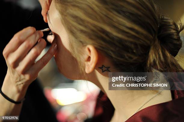 Model is being maked-up prior Elena Miro Fall-Winter 2010-2011 ready-to-wear collection on February 24, 2010 during the Women's fashion week in...