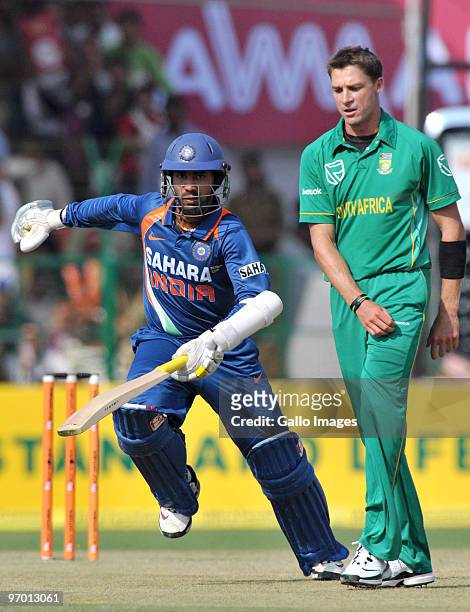 Dinesh Karthik of India runs a single past Dale Steyn of South Africa during the 2nd ODI between India and South Africa at Captain Roop Singh Stadium...