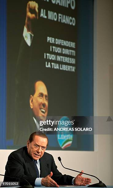 Italian Prime Minister Silvio Berlusconi speaks during a meeting as he promotes a candidate for the next regional elections at Temple of Hadrian in...