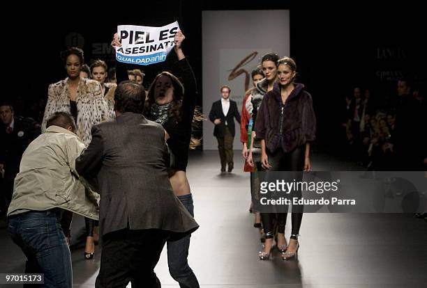 Animals rights campaigners protest against the use of fur in the garments with the slogan 'fur is murder' at Jesus Lorenzo show during Cibeles Madrid...
