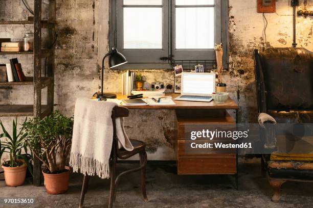 old desk with laptop in a loft - schreibtischlampe stock-fotos und bilder